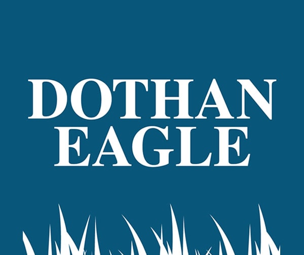 White text reading DOTHAN EAGLE on a blue background, with white grass-like shapes at the bottom.